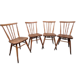 A set of four Ercol dining chairs - the rail back and stick splats joining the peripheral