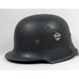 A German Stahlhelm M1944 variant - with webbing interior and unit decals.