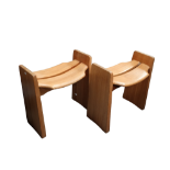 A pair of pine stools by Gilbert Marklund for Furusnickarn - with saddle shaped seats and solid