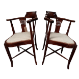 A pair of Edwardian mahogany corner chairs - incorporating foliate inlay and pierced vase shaped