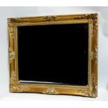 A late 20th century gilt swept frame - with flower and foliate corners, fitted with a bevelled
