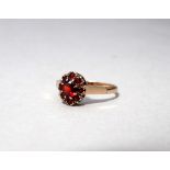 A 9ct yellow gold garnet cluster ring - size N, weight 2.5g.