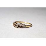 A 9ct yellow gold diamond set dress ring - the stones mounted in a crossover leaf setting, size P,