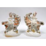 A pair of late 19th century Staffordshire figures - showing a young boy and girl, each astride a