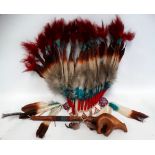 A native American feathered headdress - with blue and red feathered tips, a beaded brow band and