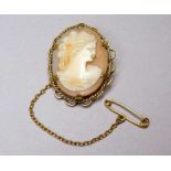 An early 20th century cameo brooch - decorated with the head of a young woman and set within a