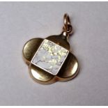 A yellow metal lobed pendant - possibly 9ct, set with a quartz tile with gilt flecks, possibly