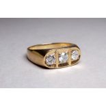 A gentlemans 9ct yellow gold three stone diamond ring - the bright cut stone in a rub-over