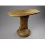 An African Turkano wooden headrest - width 21cm, height 17cm.