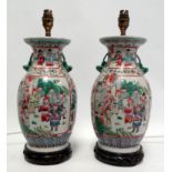 A pair of Chinese 20th century famille verte baluster shaped vases - decorated with panels showing