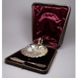 A silver butter dish - Chester 1897, Hilliard & Thomason, in the form of a scallop shell and