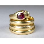An 18ct yellow gold garnet set ring - fashioned in the form of a snake, size K, weight 10g.