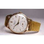 A 9ct gold watch by J W Benson, London - the white dial with an arrangement of dagger and dot