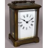 A 20th century brass carriage timepiece - the white enamel dial set out in Roman numerals, height