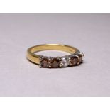 A five stone diamond ring - with fancy dark yellow stones flanking a central clear stone, set in a