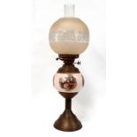 An early 20th century ceramic and brass oil lamp - with an etched glass globe shaped shade, height