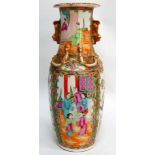 A late 19th century Cantonese vase - decorated with panels depicting figures in an interior and gilt