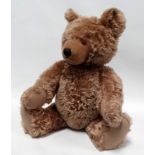 A Steiff articulated teddy bear - with growler and button to ear, height 60cm.