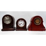 A 20th century oak cased mantel clock - the arched case with applied swags, the silvered dial set