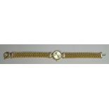 A ladies wristwatch with 9ct yellow gold case and strap - the gilt dial with baton numerals, the