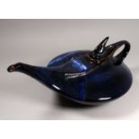 An unusual French contemporary teapot - of squat form in a dark blue marbled glaze, width 35cm.