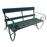 A late 19th century garden bench - the wrought steel scrolled ends with arms, joined by wood