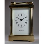 A 20th century carriage timepiece - retailed by H Samuel, the brass corniche case with four bevelled