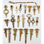 A collection of twenty-two pocket watch keys - yellow metal and gilt, many set with hardstones (