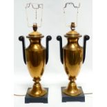 A pair of 20th century brass table lamps - of urn form with ebonised handles and raised on square