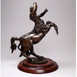 A late 19th century bronze spelter casting of a centaur - on a circular wooden base, height 20cm.