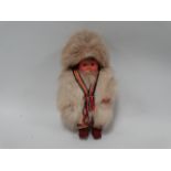 An Inuit doll - with hooded fur coat, height 37cm.