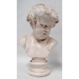 After Francois Duquesnoy - a late 19th century plaster bust of a young boy raised on a socle base,