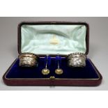 A boxed pair of silver salts - London 1896, James Charles Jay, foliate repousse decoration with gilt