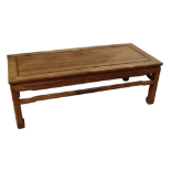 A 20th century Chinese huanghuali low table - the rectangular panelled top above stretchers and