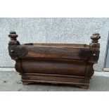 A continental hardwood trough - with a sloping moulded front, octagonal terminals and wrought