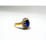 An 18ct yellow gold sapphire and diamond set ring - the oval cut sapphire 1.5ct approximately,