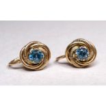 A pair of 9ct yellow gold and spinel set ear clips - the stone claw set on a knot ground, with screw