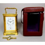 A 20th century carriage alarm clock - with a brass corniche case and white enamel dial, the movement