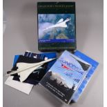 A quantity of Concorde memorabilia - to include a jigsaw puzzle, a DVD, a VHS and assorted pictures.