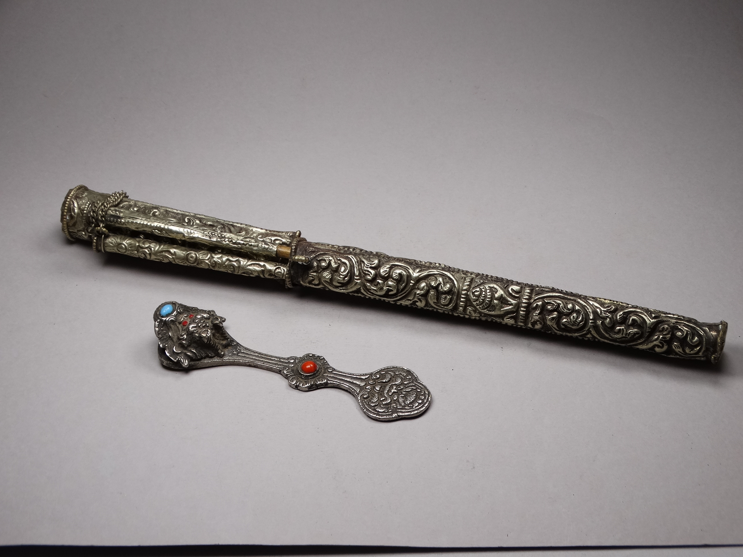A white metal knife and chopsticks set - repousse decorated with dragons and flowers, length 30cm,