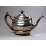 A Georgian silver teapot - London 1821, Solomon Hougham, of oval form with bright cut swagged
