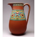 Christopher DRESSER for Watcombe Pottery - a small terracotta jug decorated with an enamel band