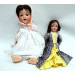 An Armand Marseille 990 baby doll - with brown sleep eyes, brown mohair wig, bent-limbed composition