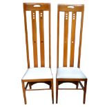 After Charles Rennie Mackintosh - a pair of oak hall chairs with typical high backs and pad