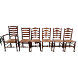 A harlequin set of six ash and beech ladderback chairs - including one with open arms, with shaped