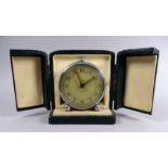 A mid 20th century Smiths travelling alarm clock - with circular chrome case and two tone dial set