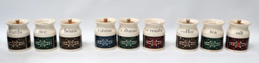 A set of nine Hornsea style kitchen canisters - decorated with an Aztec pattern on a cream ground