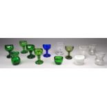 Thirteen various glass eye baths - a variety of forms and shapes.