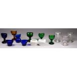 Thirteen various glass eye baths - a variety of forms and shapes.