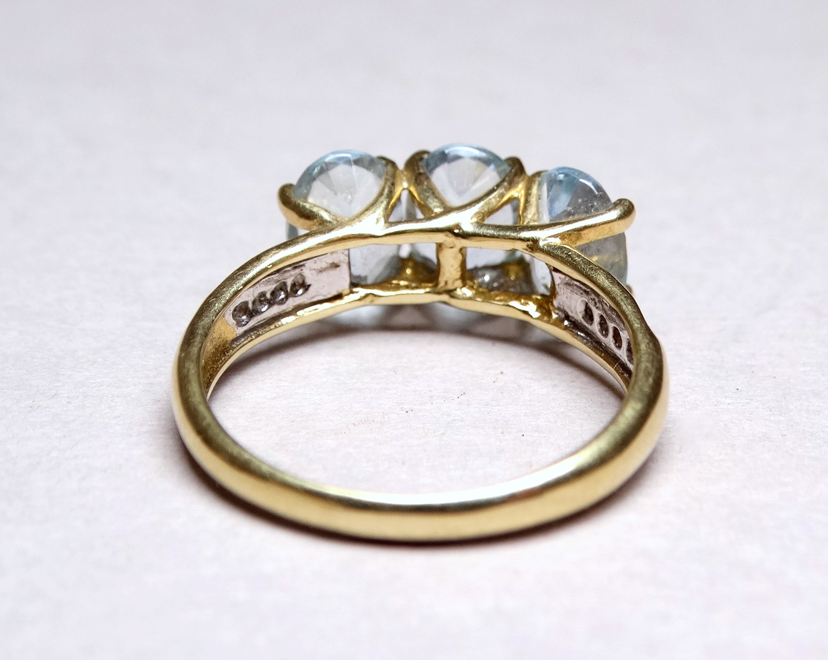 A three stone 9ct yellow gold dress ring - the aqua coloured stones claw set with diamond studded - Image 3 of 3